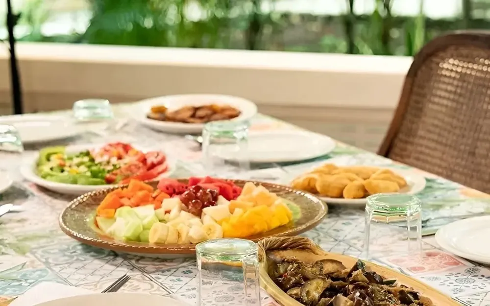 Vibrant tropical breakfast with fruit and pastries on a colorful table