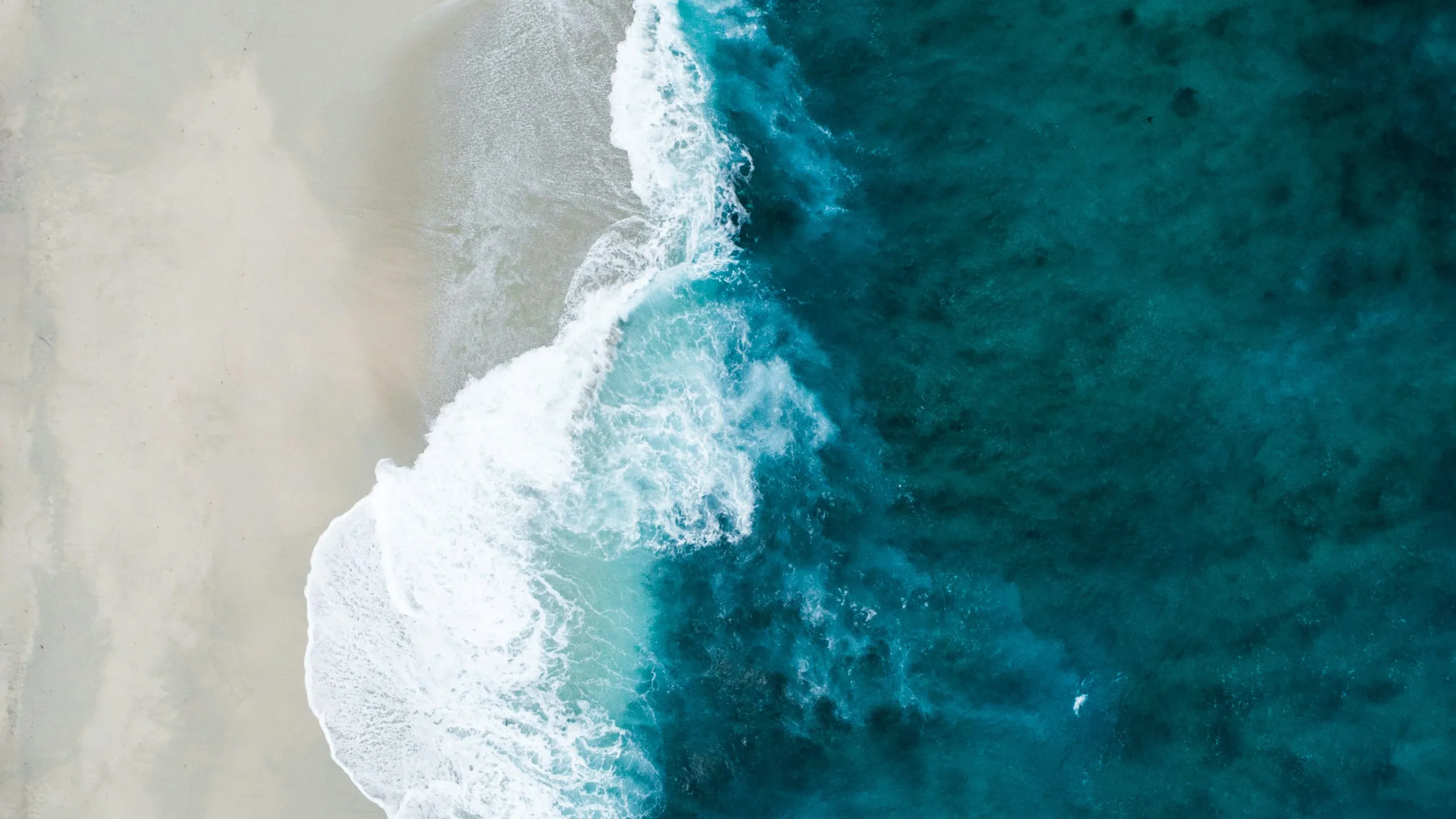 Aerial view of a serene Jamaican beach and turquoise ocean